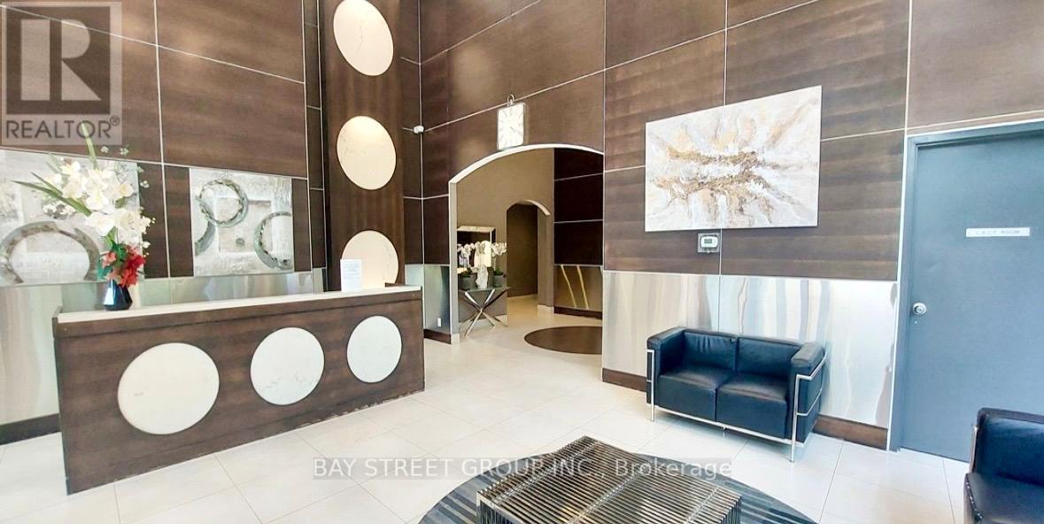 A brokerage office with a reception desk and a couch.
