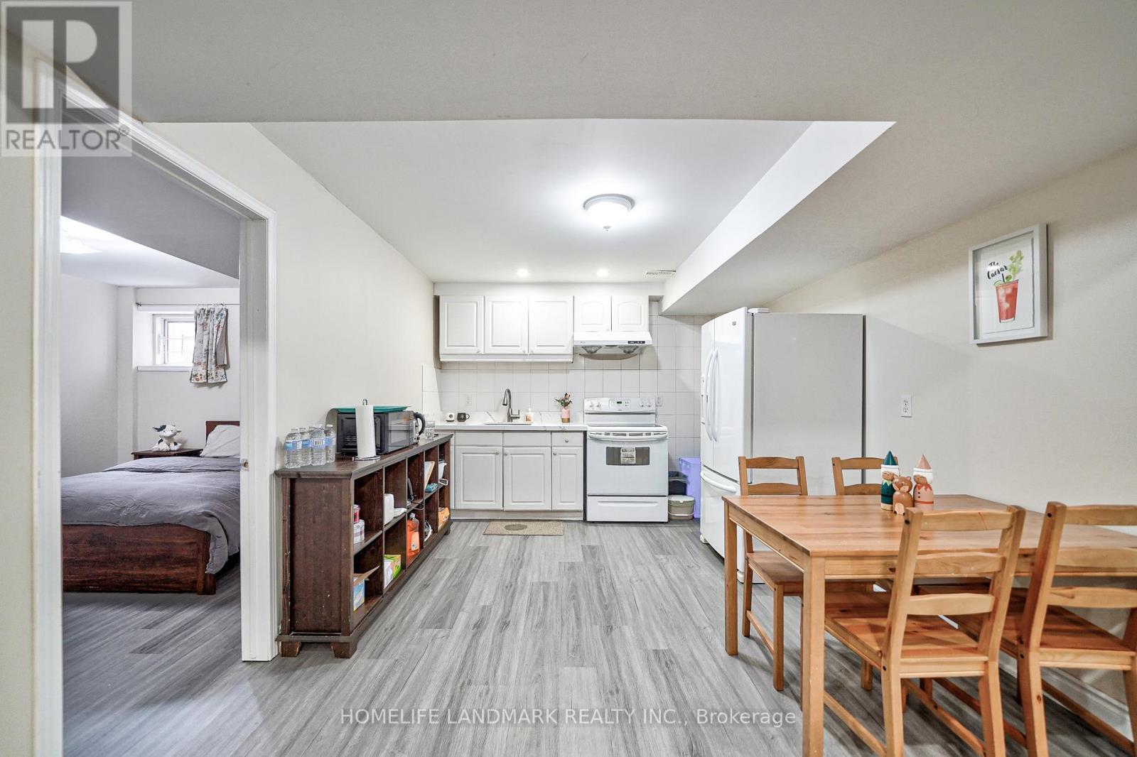 A well-lit kitchen with a dining table and chairs.