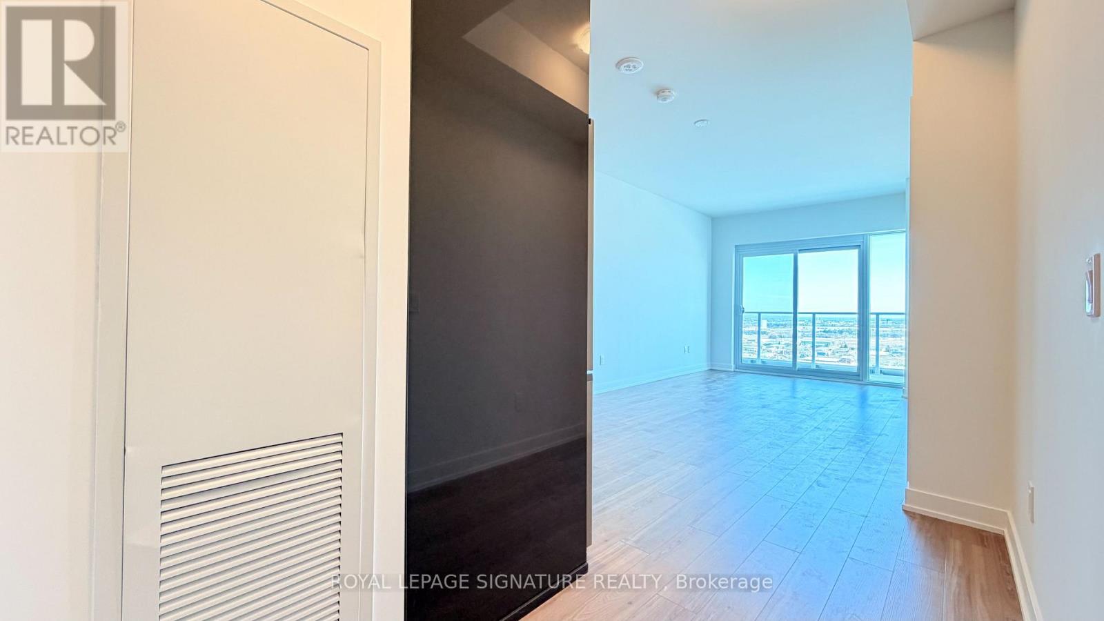 A room with a door that has a Realty logo on it.