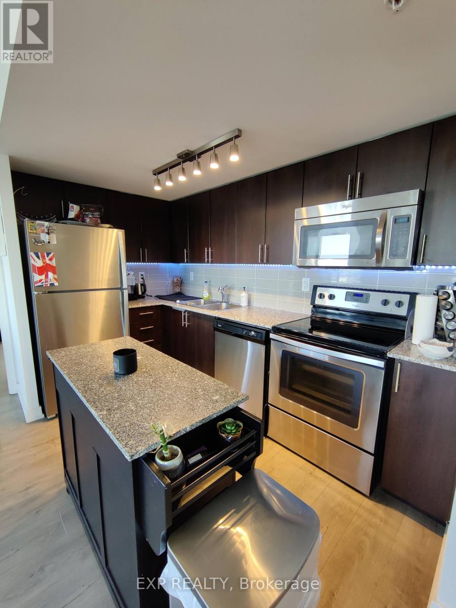 A kitchen with dark wood cabinets and stainless steel appliances.