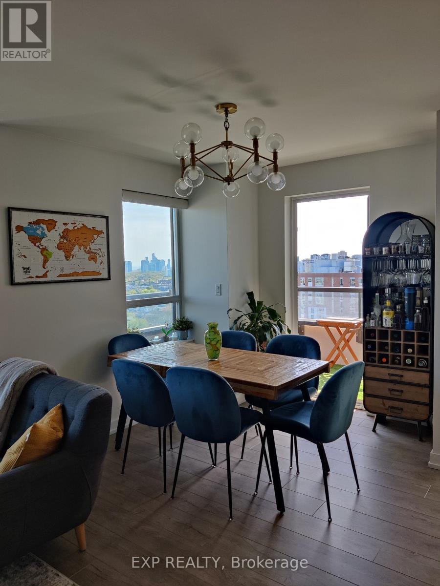 A dining room with a table and chairs and a world map on the wall.