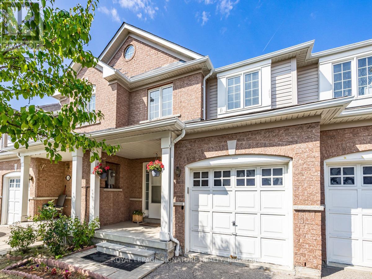 A house with a white garage door and a brick facade.