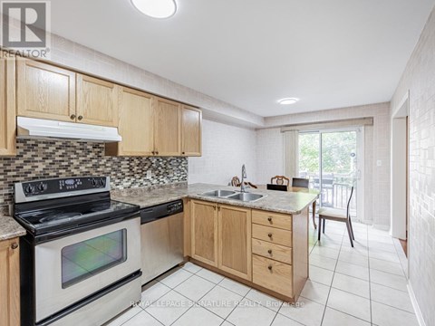 A kitchen with a stove top oven and a counter top.