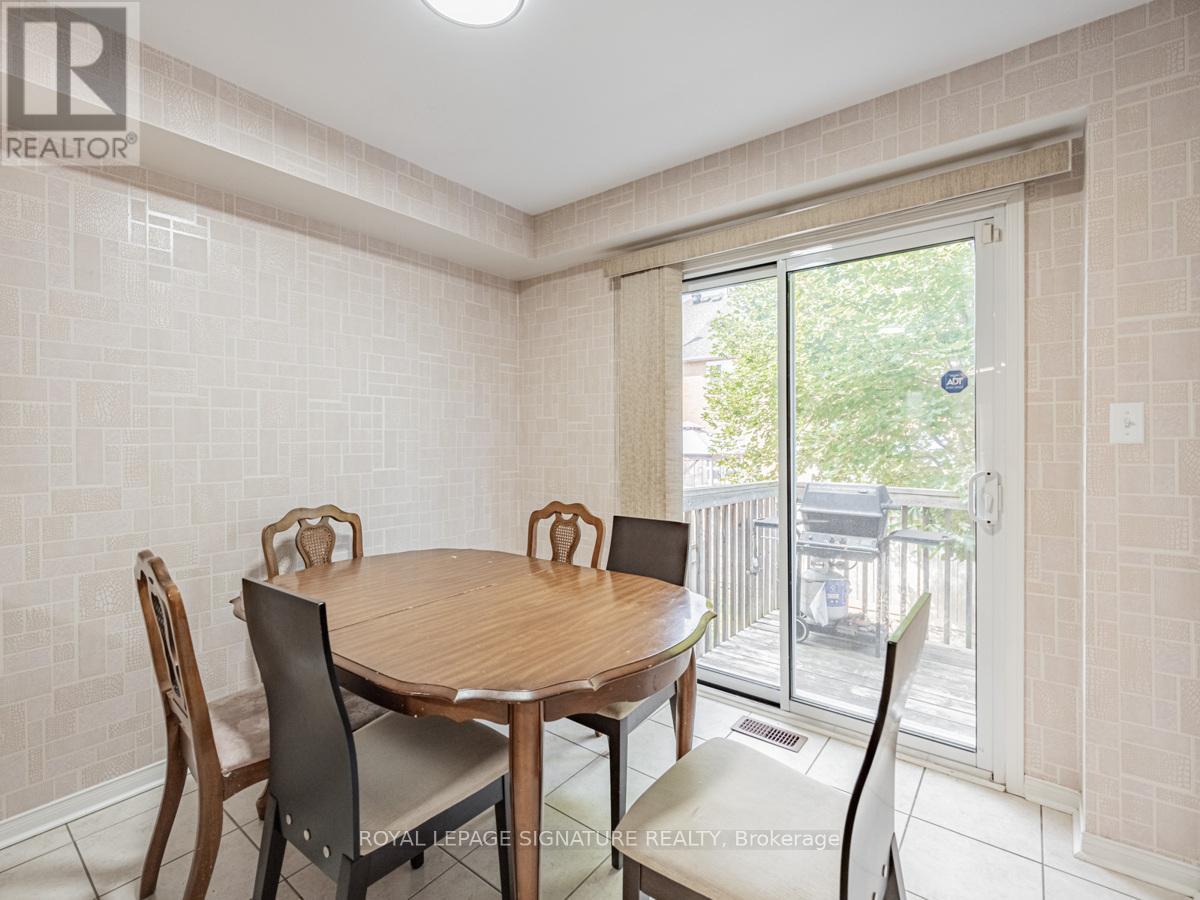 A dining room with a table and chairs.