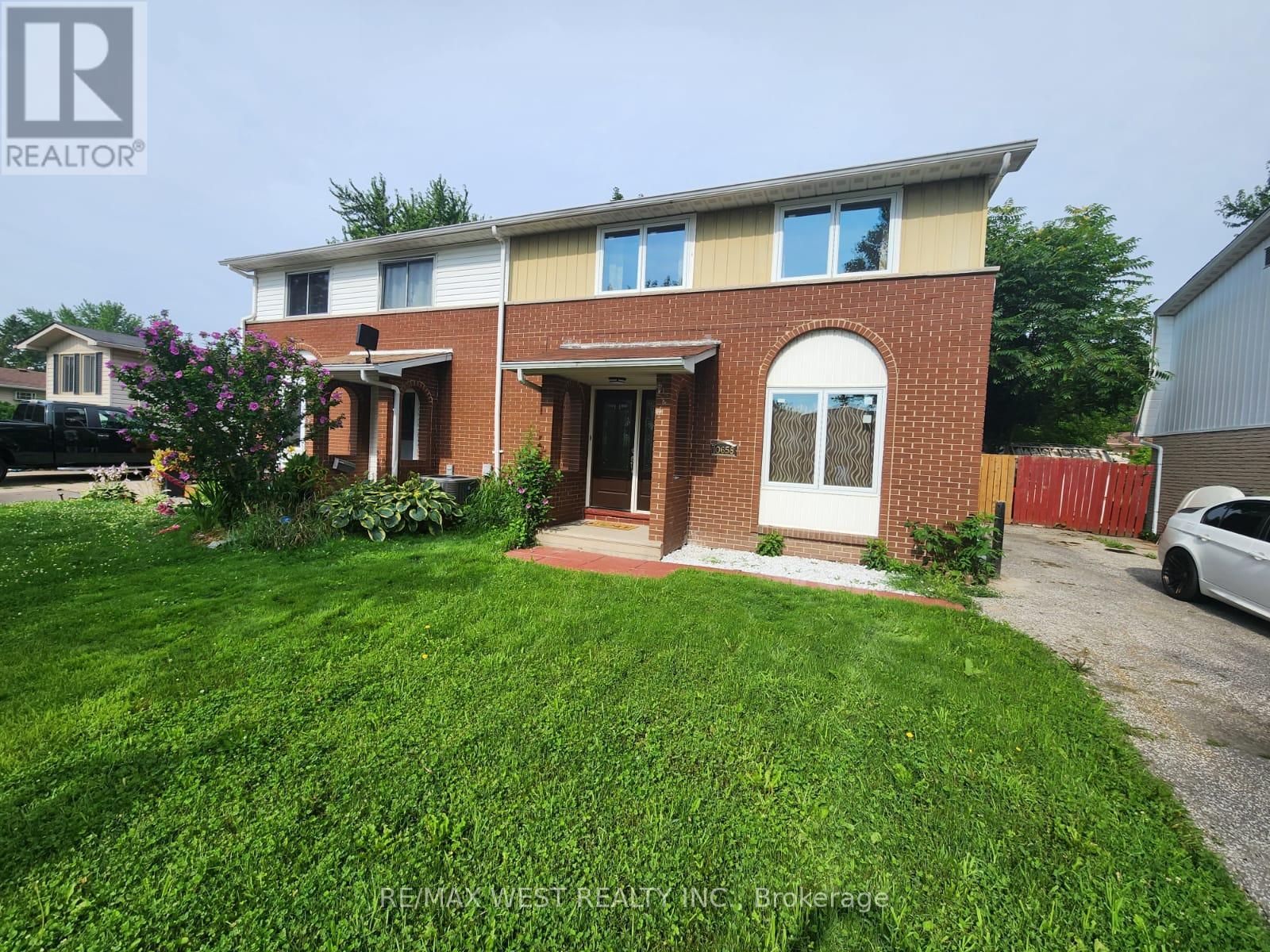 A house with a red brick facade and a white door is for sale.