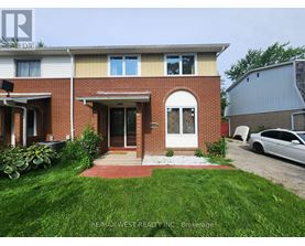 A house with a red brick facade and a white door is for sale.