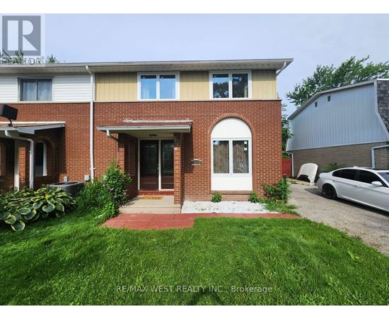 A house with a red brick facade and a white door is for sale.