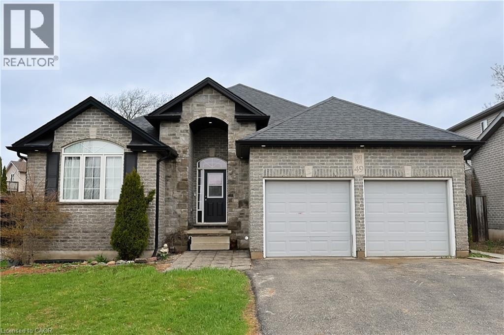 A house with a grey roof and two garages.