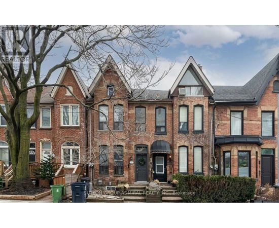 A large red brick house with a black door and windows.