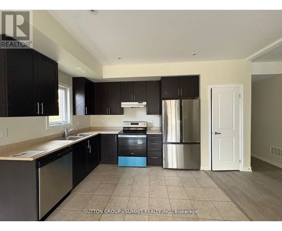 A kitchen with black cabinets and stainless steel appliances.