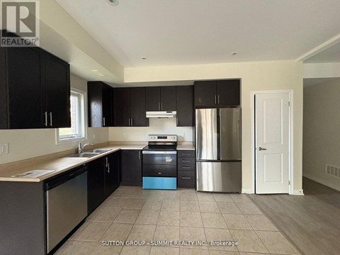 A kitchen with black cabinets and stainless steel appliances.