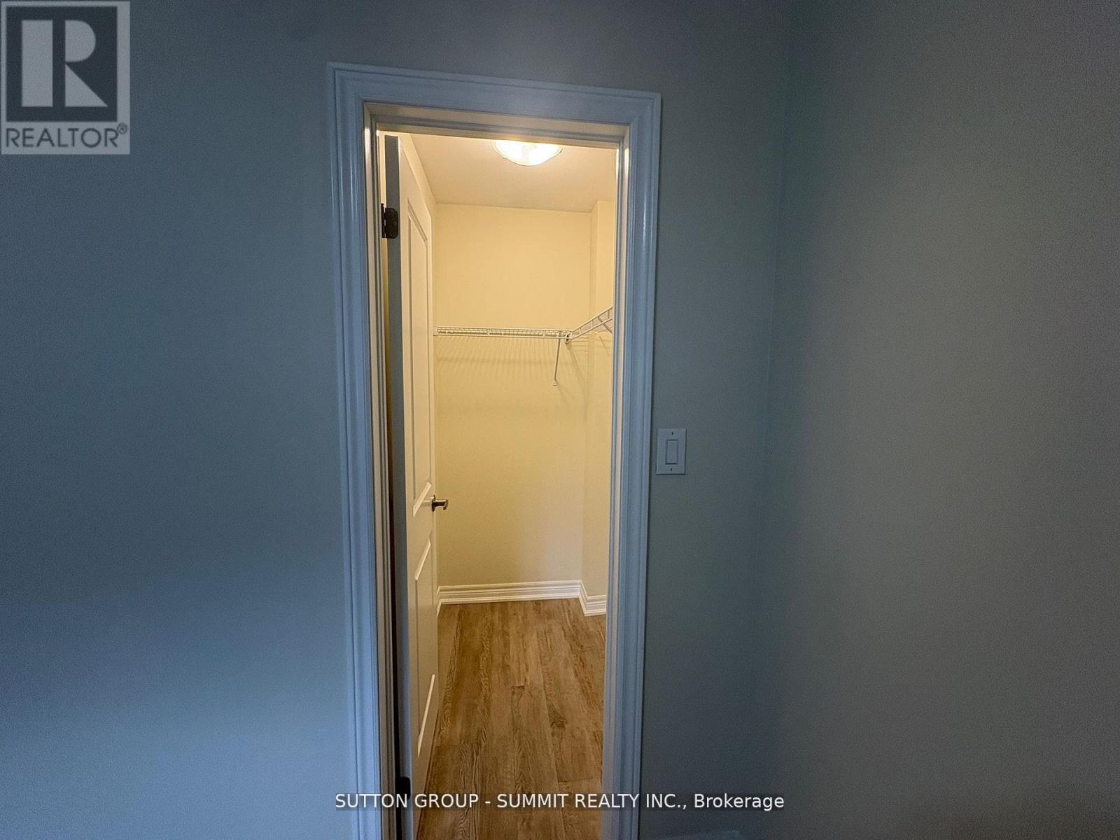 A doorway leading to a bedroom with a white door and a light on.