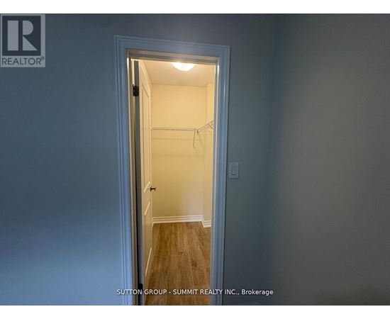 A doorway leading to a bedroom with a white door and a light on.