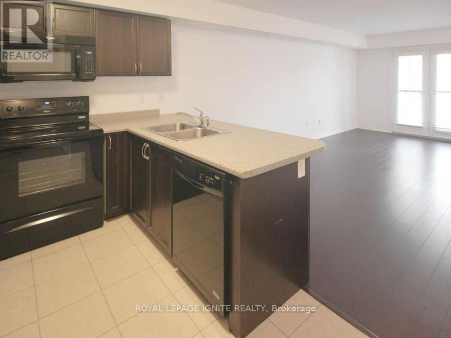 A kitchen with a sink, stove, and oven.