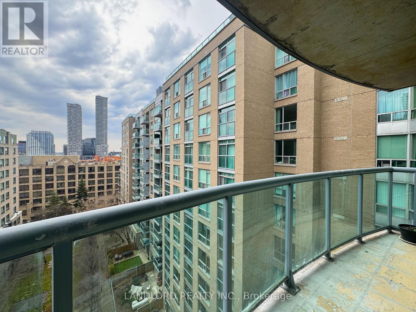 A balcony overlooks a cityscape with tall buildings.
