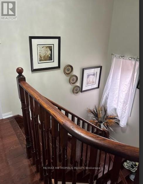 A wooden staircase with a white curtain on the side.