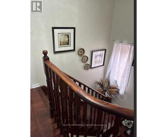A wooden staircase with a white curtain on the side.