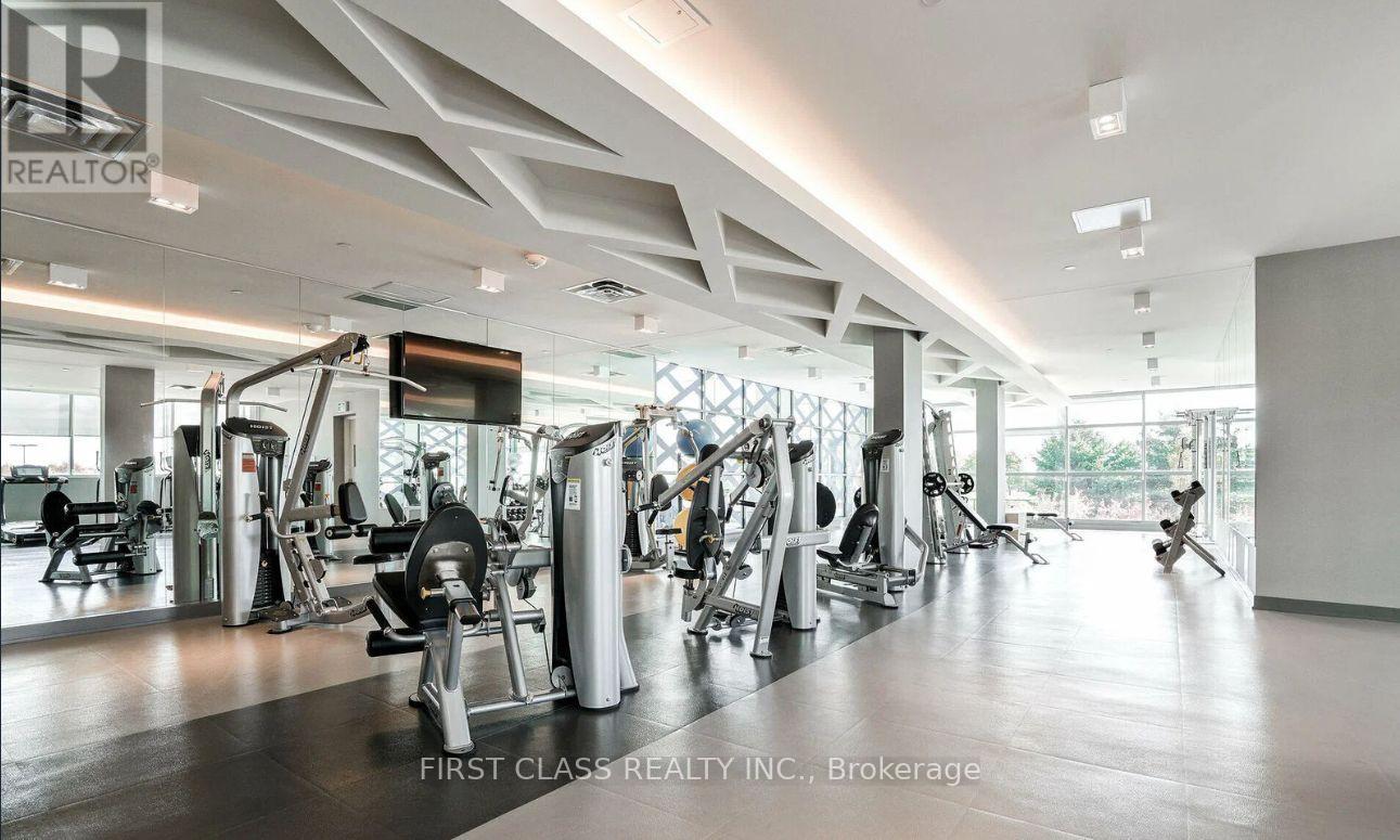 A gym with a variety of equipment is labeled as being owned by First Class Realty Inc.