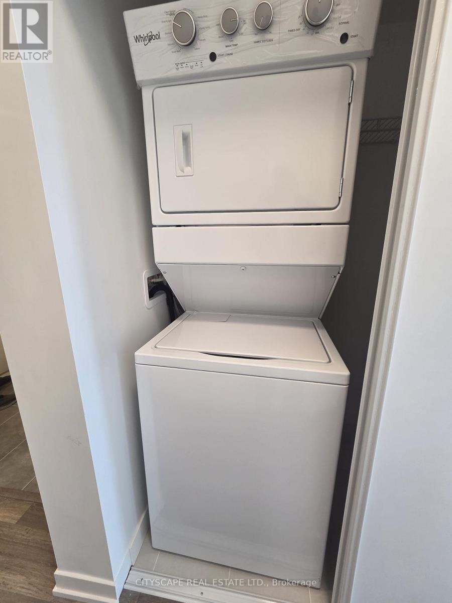 A white Whirlpool dishwasher and dryer are stacked on top of each other.