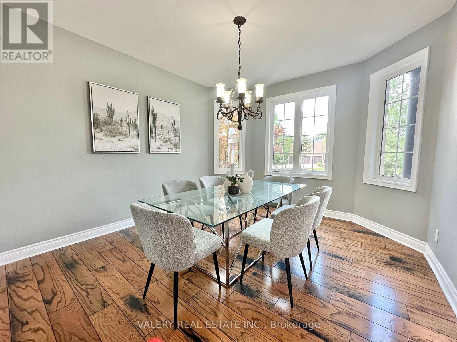 A dining room with a glass table and chairs.