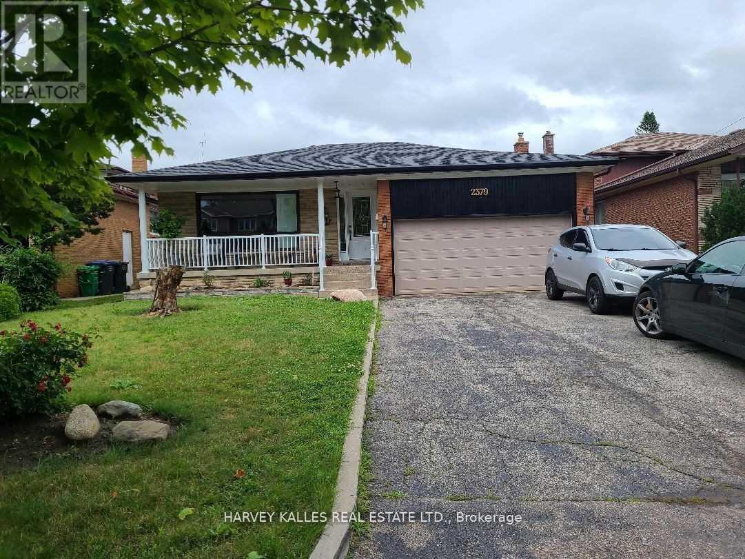A house with a garage and a car parked in front.