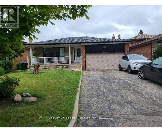 A house with a garage and a car parked in front.