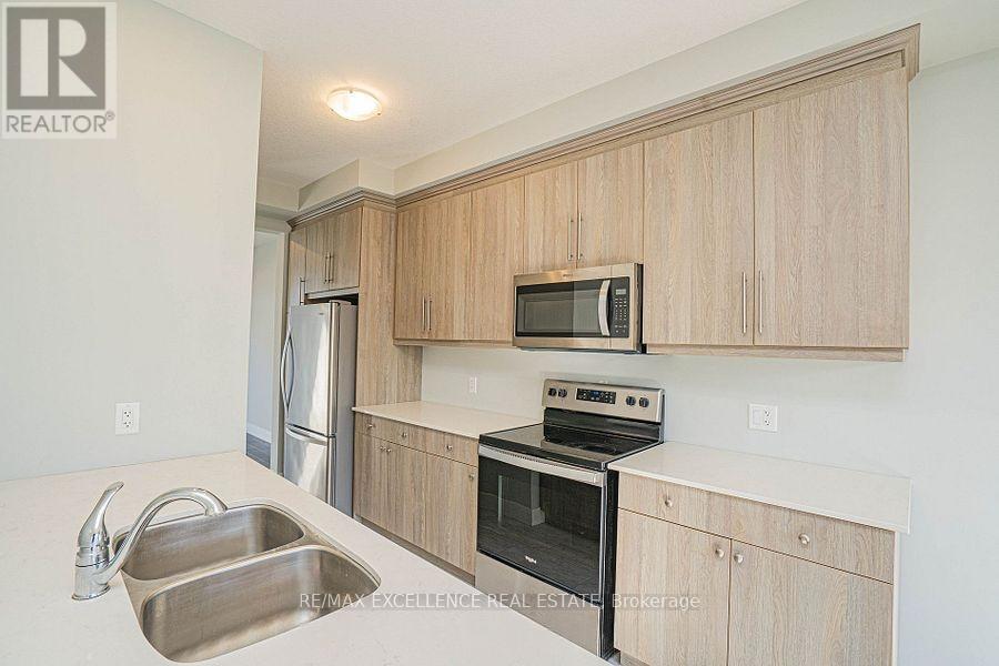 A kitchen with wooden cabinets and stainless steel appliances.