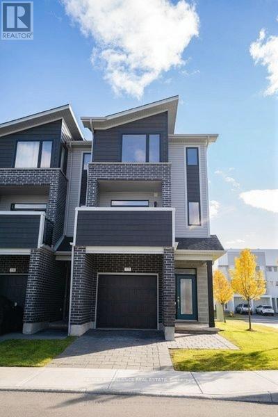A modern two-story house with a garage is showcased in the image.