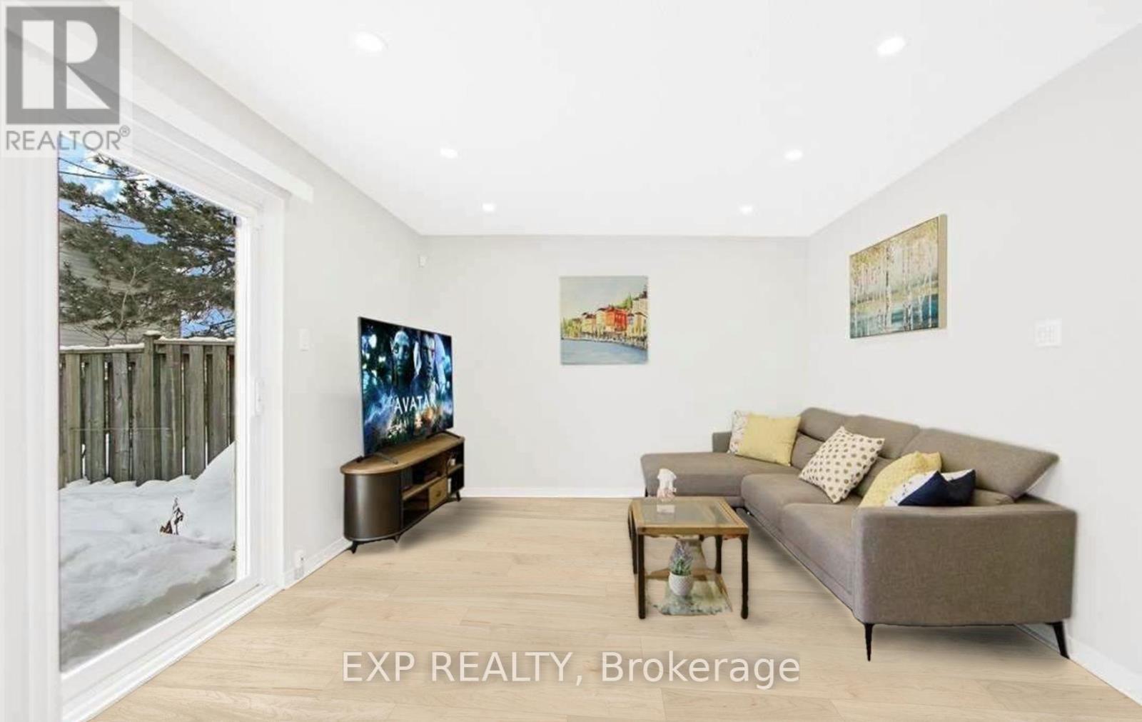 A living room with a couch, a coffee table, and a painting on the wall.