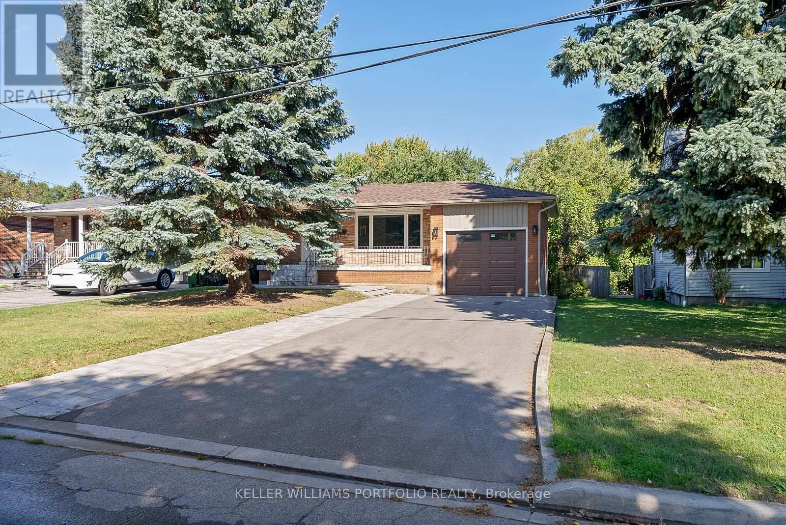A house with a brown garage door is for sale.