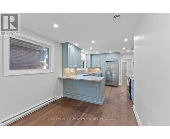A kitchen with a blue cabinet and a fridge.