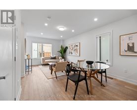 A dining room with a glass table and chairs.