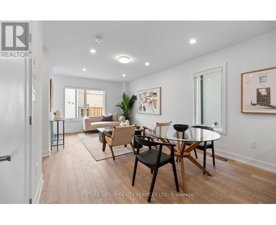 A dining room with a glass table and chairs.