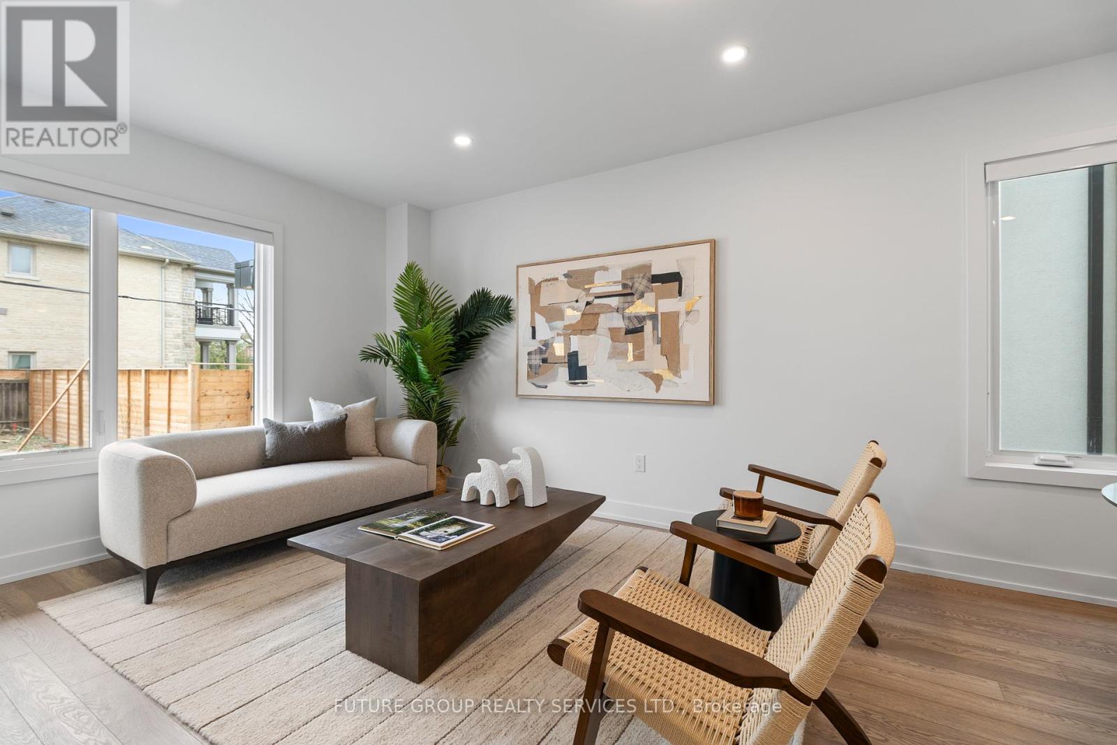 A living room with a couch, chair, and a painting on the wall.