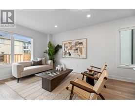 A living room with a couch, chair, and a painting on the wall.