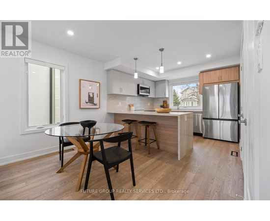 A modern kitchen with a glass table and bar stools.