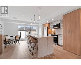 A modern kitchen with wooden cabinets and a large island.