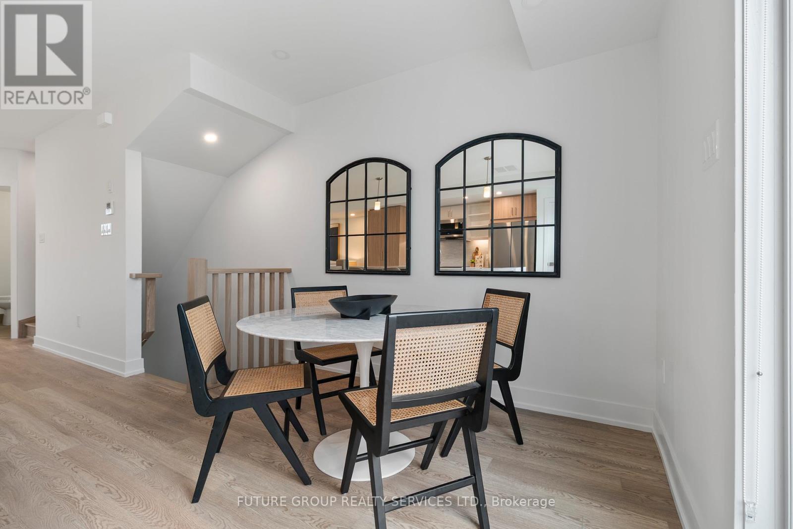 A dining room with a round table and chairs.