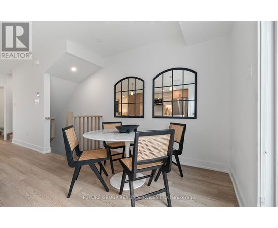 A dining room with a round table and chairs.