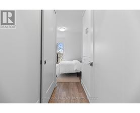 A bedroom with a bed and a window.