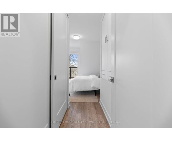 A bedroom with a bed and a window.