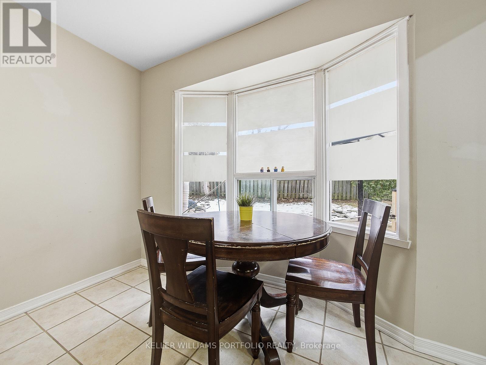 A dining room with a table and chairs.