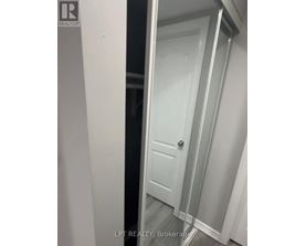 A white door is in a white room.