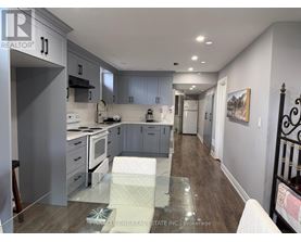 A modern kitchen with a glass table in the middle.