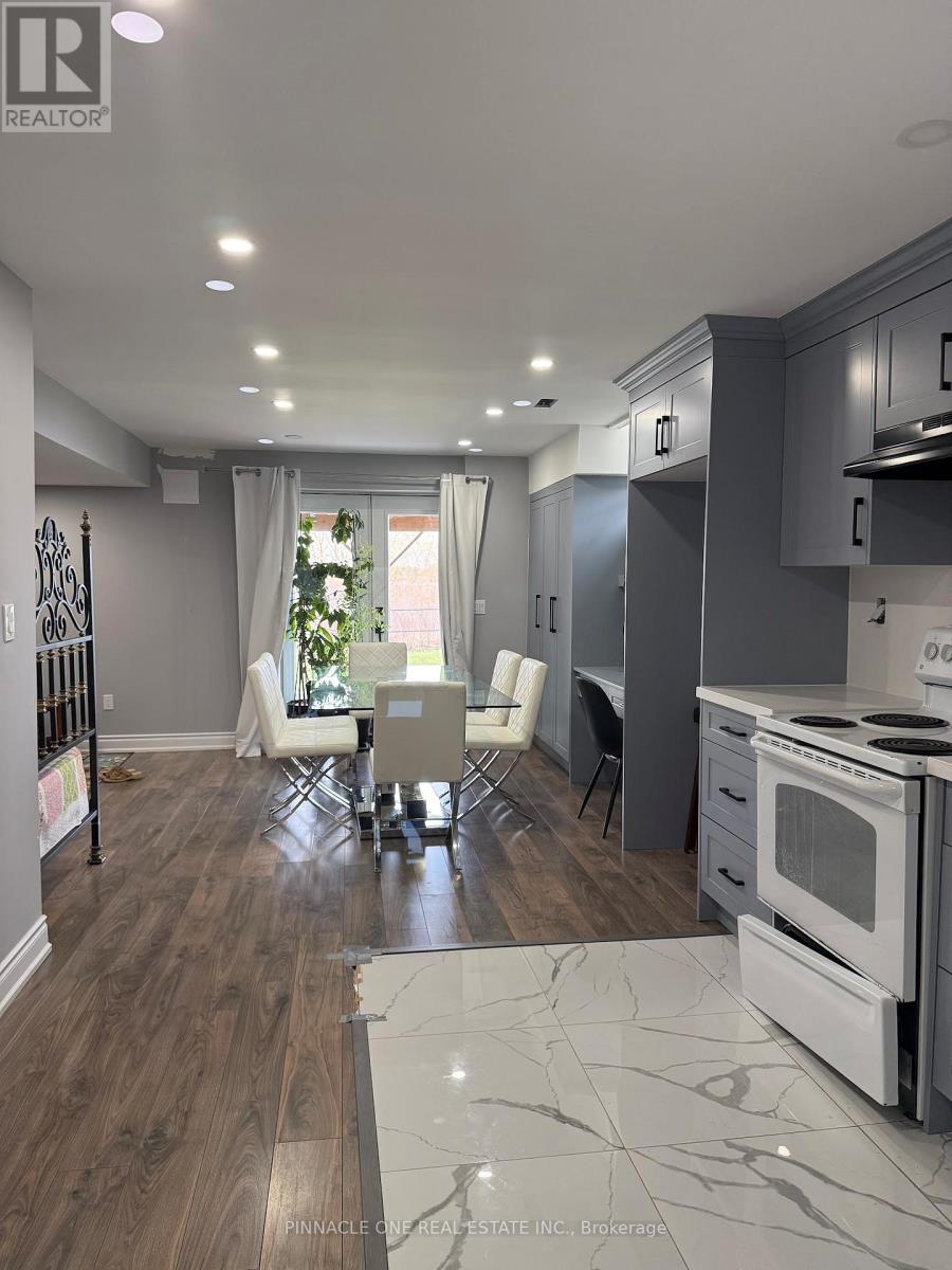 A modern kitchen with a dining table and chairs.