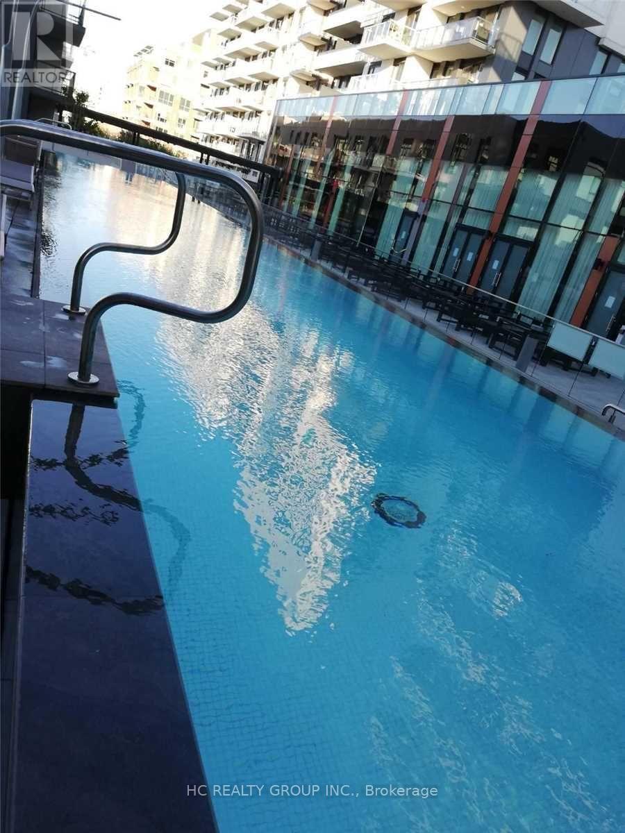 A pool with a metal railing on the side.
