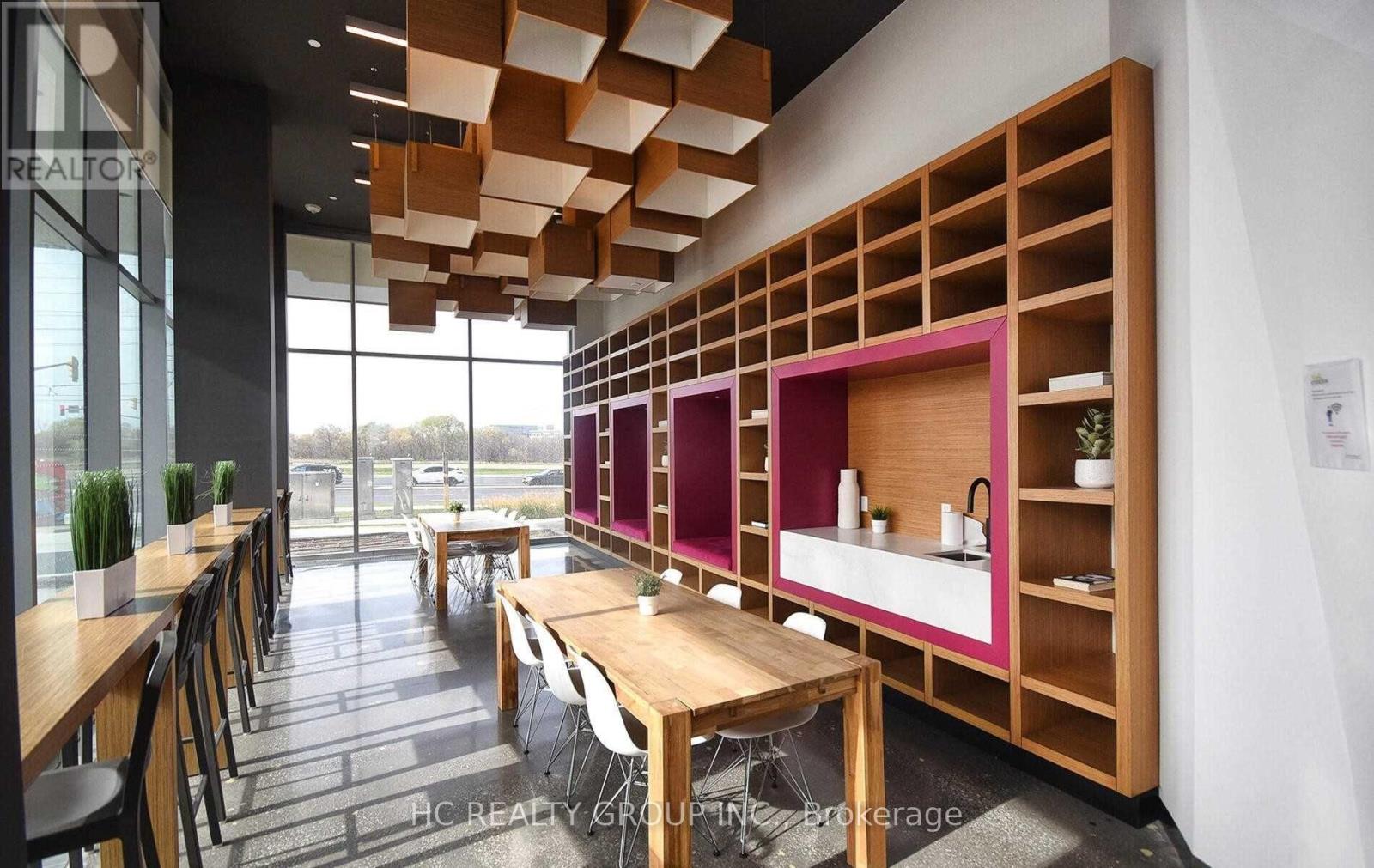 A modern dining area with wooden tables and chairs.