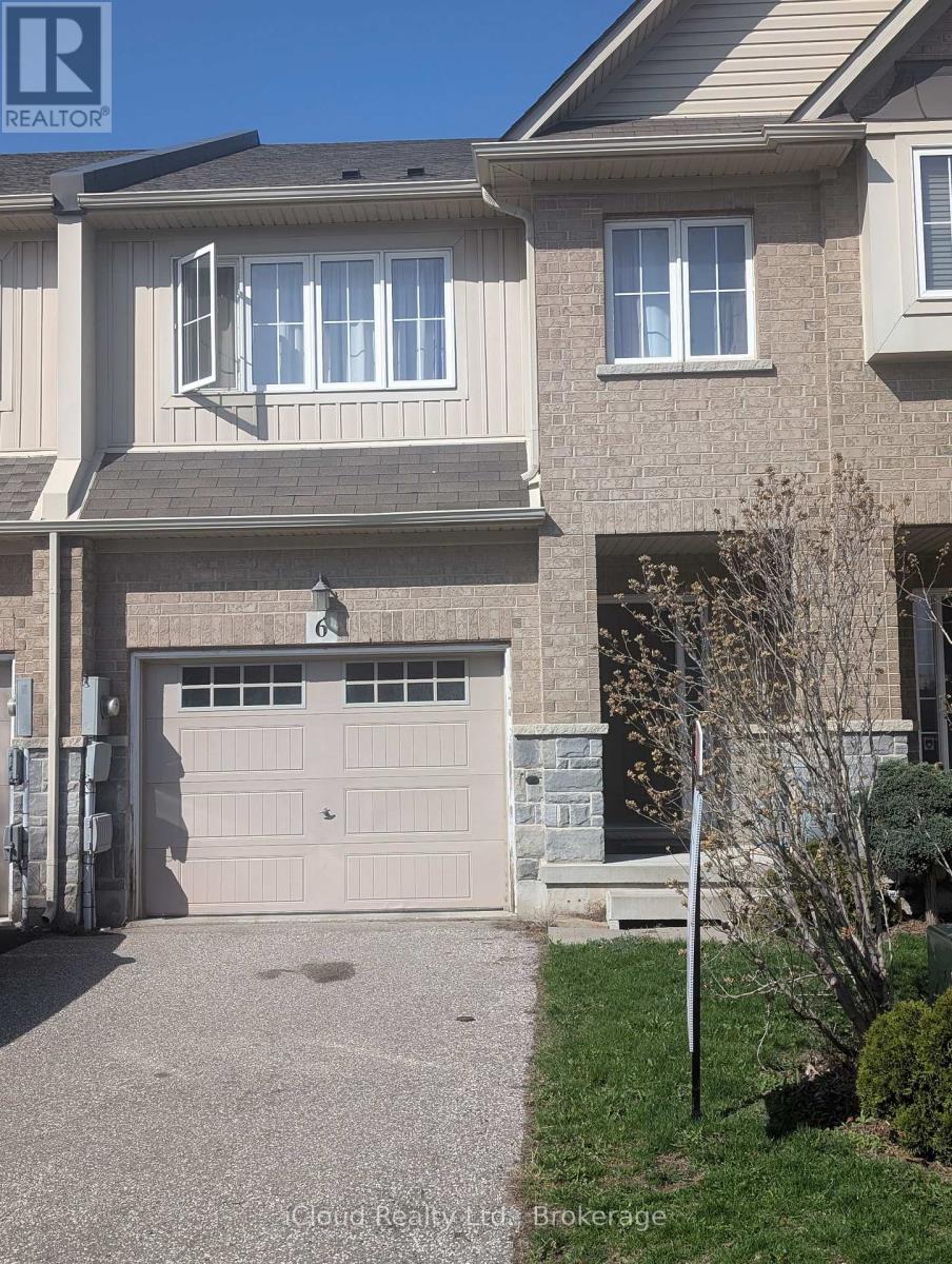 A house with a grey garage door and a brown roof.