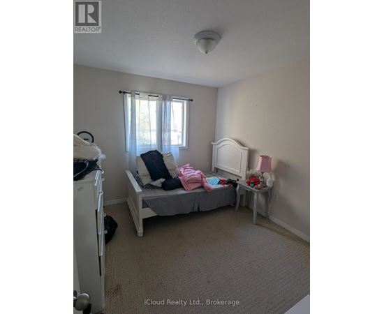 A bedroom with a bed, a dresser, and a window.