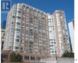 A tall building with many windows is shown in the image.